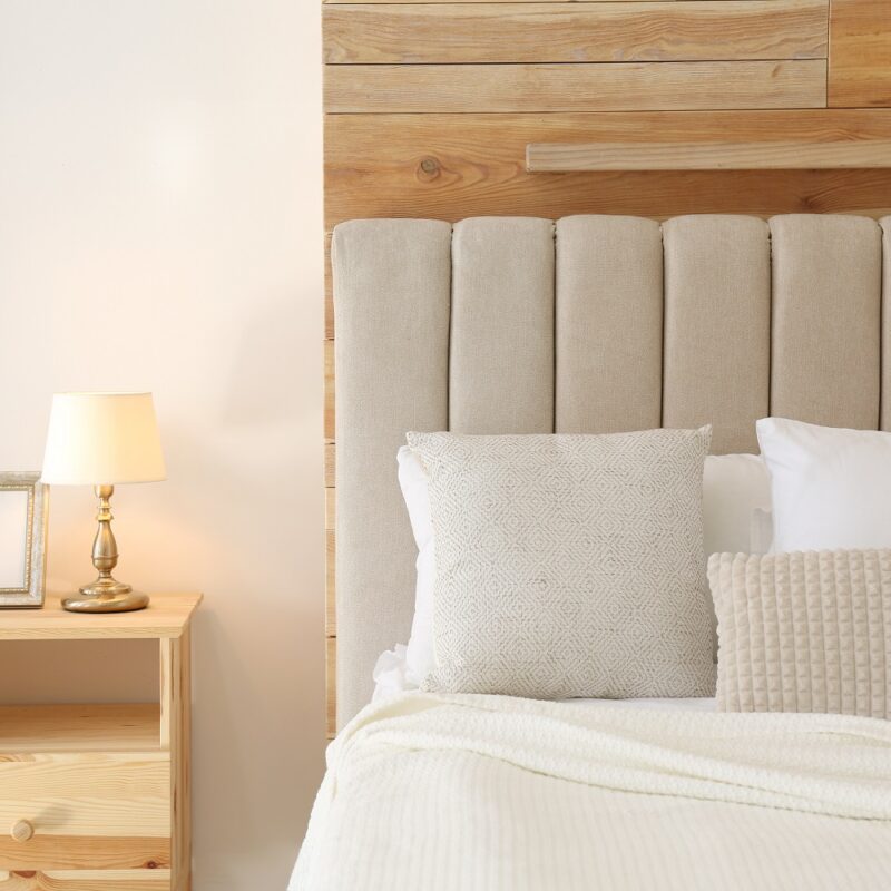 Comfortable bed with pillows in modern room interior